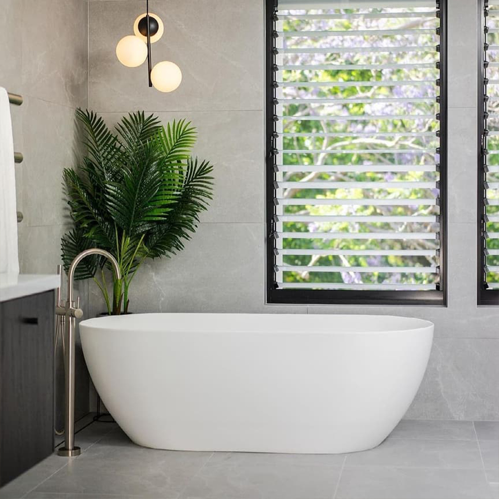 Luxury Bathroom | Capture the perfect space of relaxation with low lighting above your freestanding bath for a zen bathroom like @abeyaustralia's
